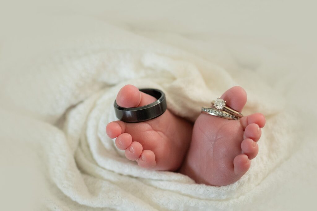 A close-up of baby James’ tiny toes and soft curls, captured in soft natural light. The muted olive green background nods to the family’s love for Ireland during this in-home newborn session in Sacramento.